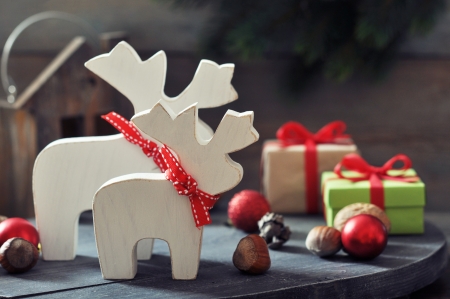 Christmas decorations in shape of elks with gift boxes on wooden の写真素材