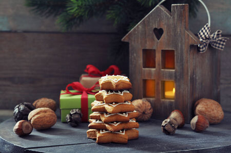 Fir tree from ginger biscuits with lantern and gift boxes on a wooden の写真素材