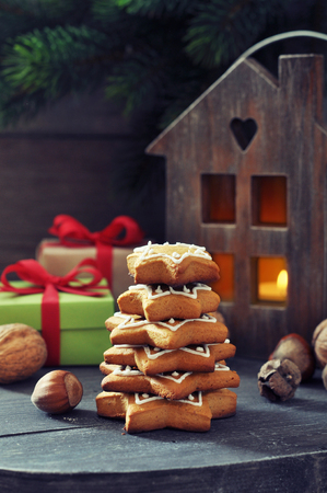 Fir tree from ginger biscuits with lantern and gift boxes on a wooden の写真素材