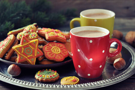 Two cups of hot chocolate and ginger biscuits on a wooden の写真素材