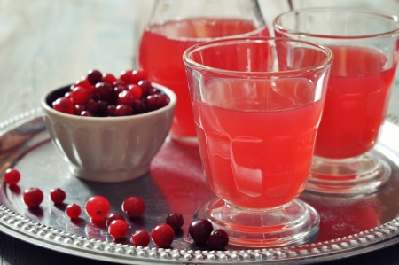 Cranberry juice in glass with fresh berry on wooden backgroundの写真素材