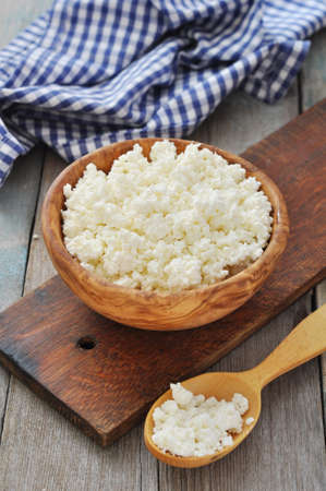 Fresh cottage cheese in wooden bowl closeupの写真素材