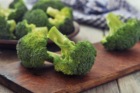 Bunch of fresh green broccoli on wooden cutting board  closeupの写真素材