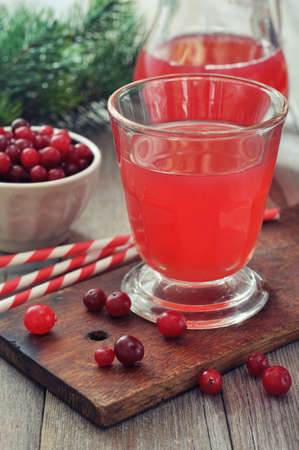 Cranberry juice in glass with fresh berry on wooden backgroundの写真素材