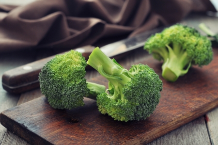Bunch of fresh green broccoli on wooden cutting board  closeupの写真素材