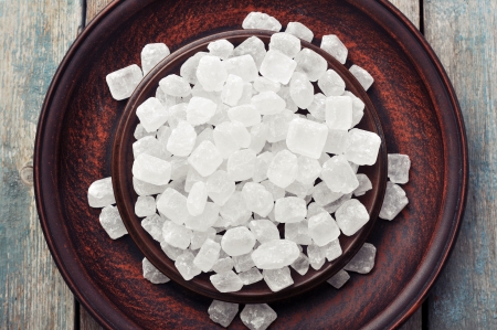 White candy sugar on brown plate. Top view.の写真素材