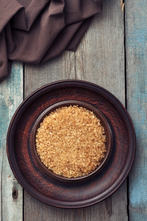 Brown candy sugar on brown plate. Top view.の写真素材