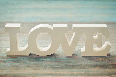 The word Love on a wooden background closeupの写真素材