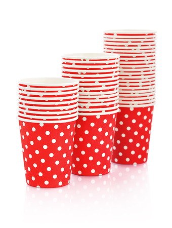 Red polka dot paper cups isolated on white. の写真素材