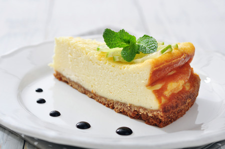 Cheesecake with lime and mint on plate closeupの写真素材