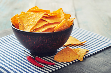 Corn nachos in bowl on wooden tableの写真素材