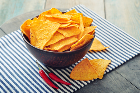 Corn nachos in bowl on wooden tableの写真素材