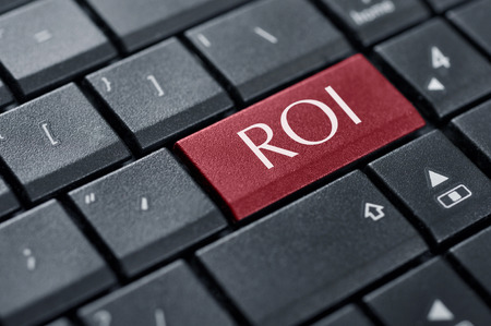 Return on Investment concept. Word ROI on button of computer keyboard.の写真素材