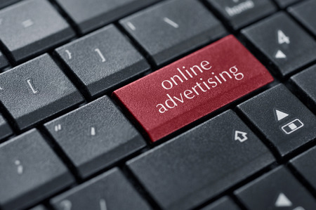 Concept of online advertising. Word online advertising on button of computer keyboard.の写真素材