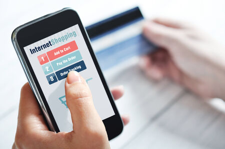 Female hands using smart phone for internet shoppingの写真素材