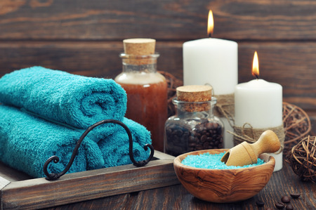 Spa composition with towels, candles and sea salt on wooden backgroundの写真素材