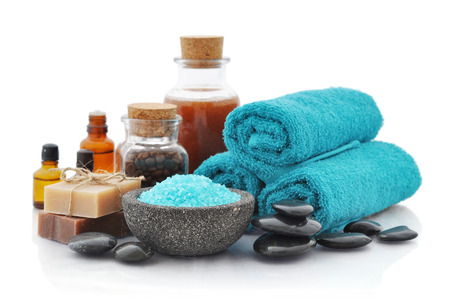 Spa composition with blue sea salt and massaging stones on isolated white の写真素材