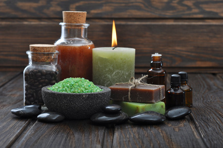Spa composition with green sea salt and massaging stones on wooden の写真素材