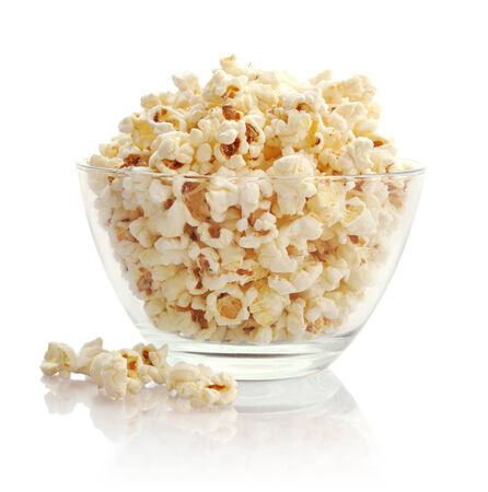 Popcorn in glass bowl  isolated on white backgroundの写真素材