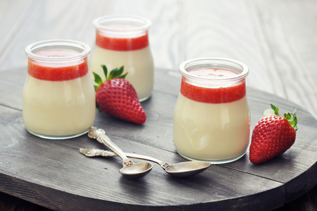 Dessert panna cotta with fresh strawberry on wooden backgroundの写真素材