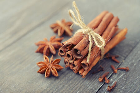 Cinnamon sticks and star anise on wooden backgroundの写真素材