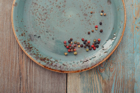 Blue plate on wooden background, top viewの写真素材
