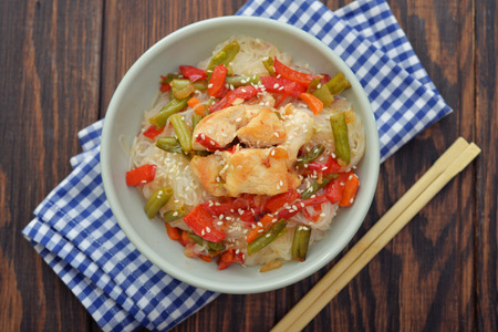 Rice noodles with chicken and vegetables in bowl top viewの写真素材