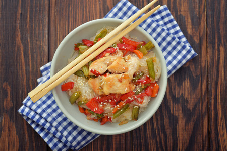 Rice noodles with chicken and vegetables in bowl top viewの写真素材