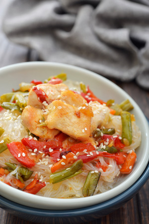 Rice noodles with chicken and vegetables in bowl closeupの写真素材
