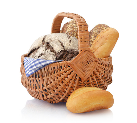 Bread and rolls in wicker basket isolated on white backgroundの写真素材