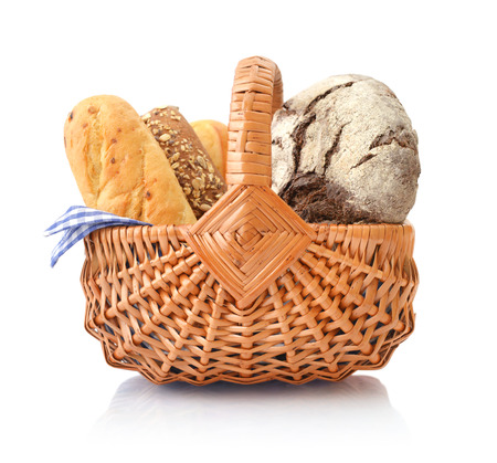 Bread and rolls in wicker basket isolated on white backgroundの写真素材