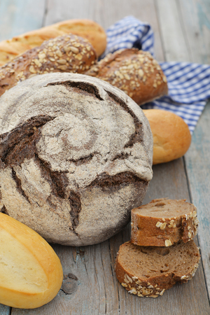 Composition with bread and rolls on wooden backgroundの写真素材
