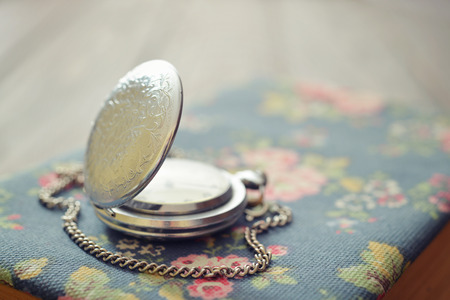 Vintage pocket watch on old book closeupの写真素材