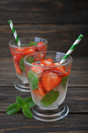 Glass with strawberry mojito on wooden の写真素材