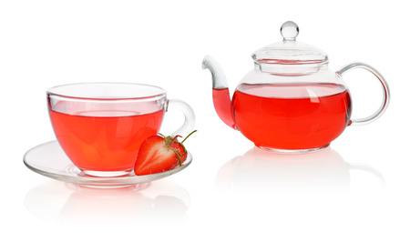 Strawberry tea in glass cup with teapot and fresh berries isolated on whiteの写真素材