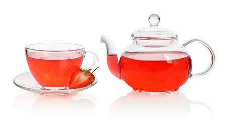Strawberry tea in glass cup with teapot and fresh berries isolated on whiteの写真素材