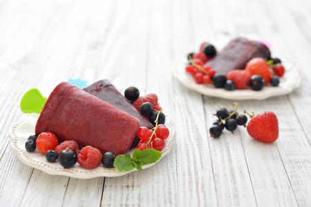 Homemade berry ice cream with fresh berries in bowl closeupの写真素材