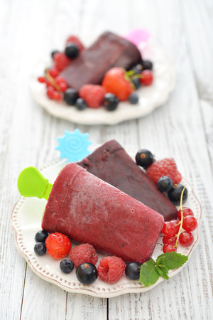 Homemade berry ice cream with fresh berries in bowl closeupの写真素材