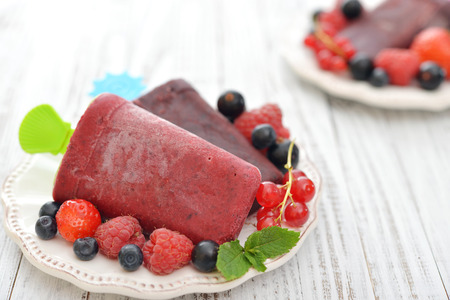 Homemade berry ice cream with fresh berries in bowl closeupの写真素材