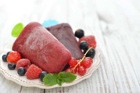 Homemade berry ice cream with fresh berries in bowl closeupの写真素材
