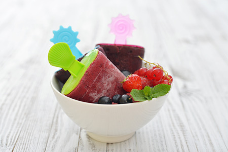 Homemade berry ice cream with fresh berries in bowl closeupの写真素材