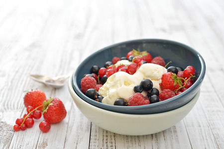 Ice cream with fresh berries in bowl closeupの写真素材