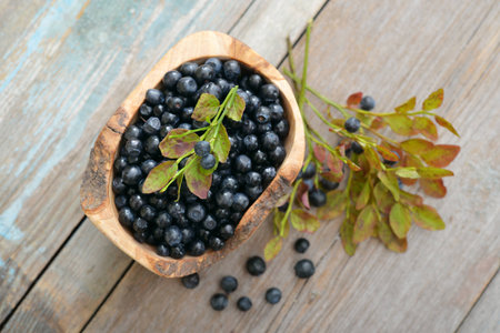 Fresh blueberry in wooden bowl on wooden backgroundの写真素材
