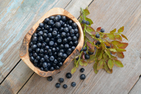 Fresh blueberry in wooden bowl on wooden backgroundの写真素材