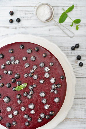 Black currant cheesecake with fresh berries on plate closeupの写真素材