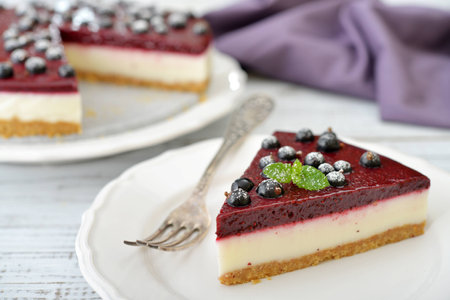 Black currant cheesecake with fresh berries on plate closeupの写真素材
