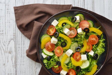 Fresh vegetable salad with cheese feta on plate closeupの写真素材