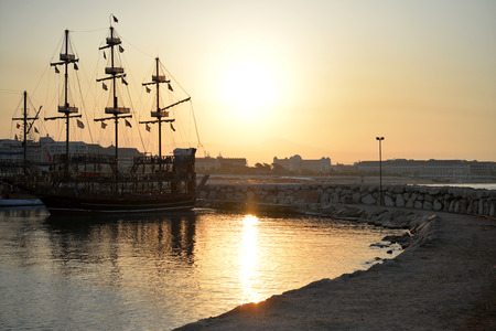 Old Pirate Ship at sea on sunriseの写真素材