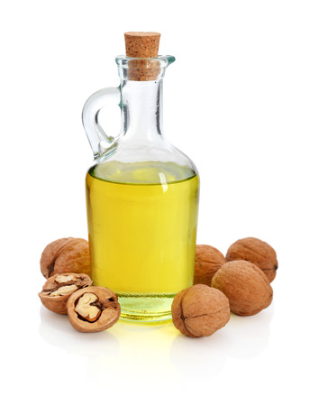 Walnut oil with nuts isolated on a white backgroundの写真素材