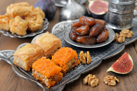 Baklava, figs, nuts and dry dates on tray. Small shallow DOFの写真素材